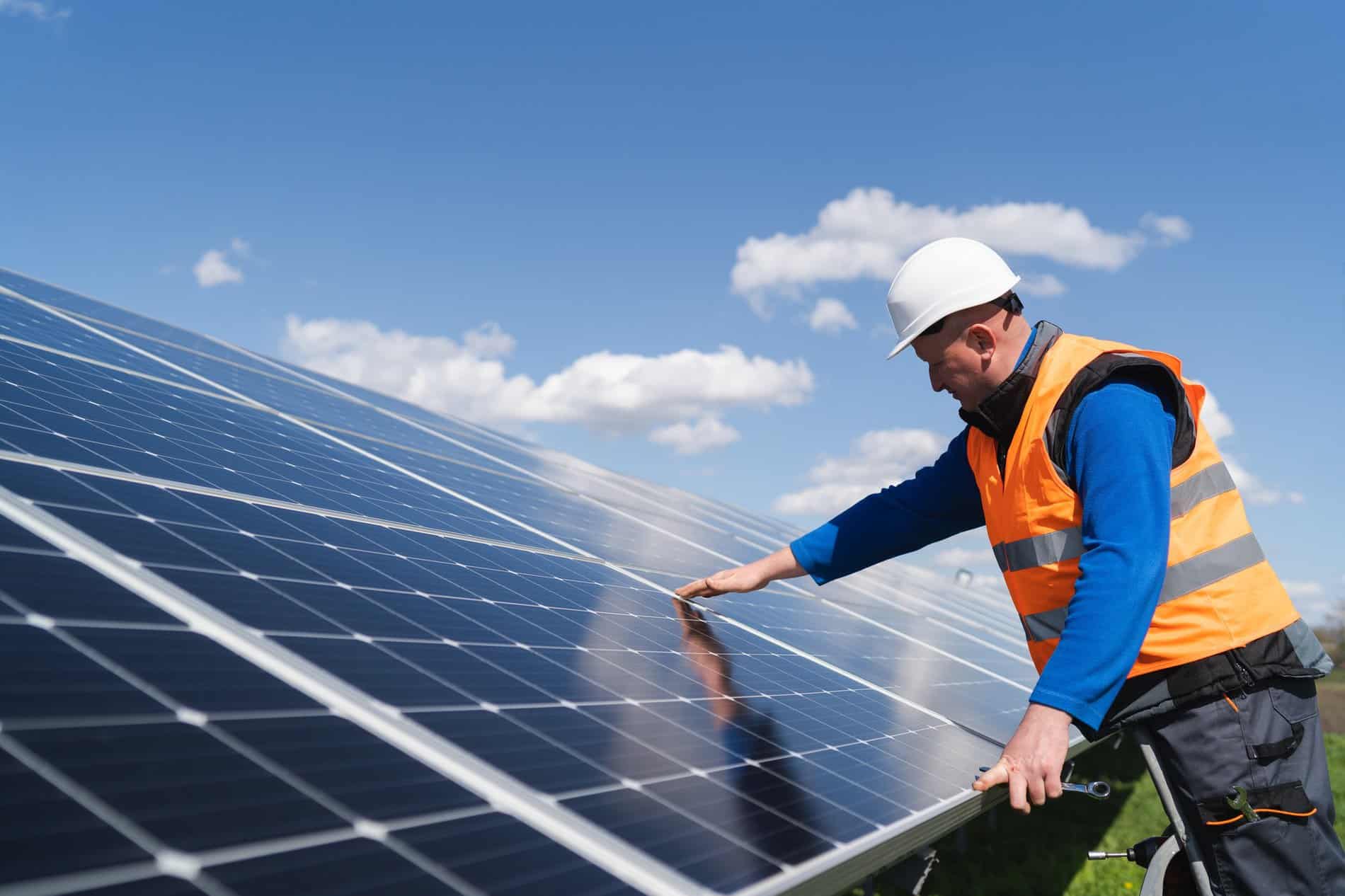 Solar power plant engineer makes a visual inspection of solar panels
